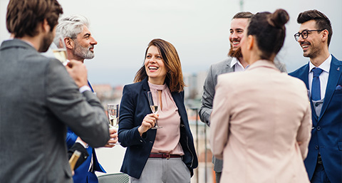 a group of a business people standing in a circle and drinking champagne 